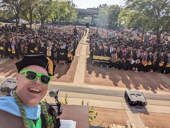 President Kevin Horan posing with graduates