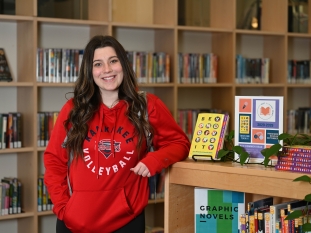 Student posing for a picture in the student success section