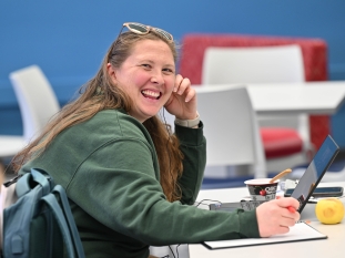 Student Kayla Wheeler smiling for the camera inside her classroom. 